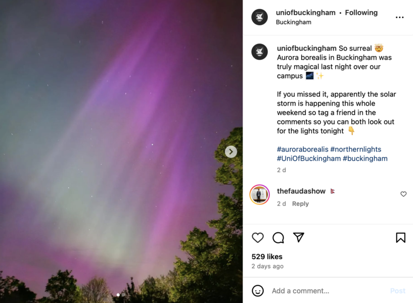 University of Buckingham instagram post with purple and green northern lights in sky over campus
