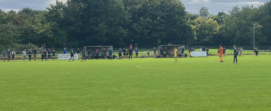 Buckingham FC players grab a drink during a break in play.